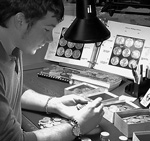 [photo: coin grader at work]